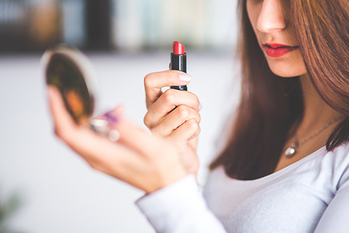 500-woman-with-brown-hair-doing-lipstick-and-holding-little-6393.jpg